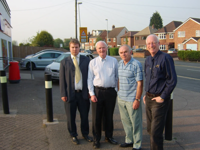 Lib Dem Councillors, David Bill, Dave Cope, Michael Mullaney and Don Wright at the front of the shop where the extra bollards are needed.